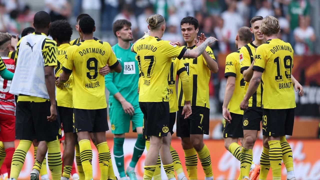 Borussia Dortmund players celebrate after the match. Credit: Reuters Photo