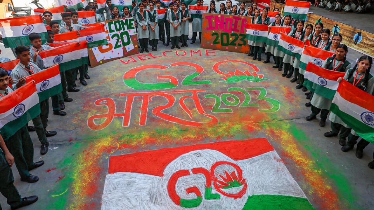 Students make a 'rangoli' of G20 logo ahead of G20 meetings, in Srinagar, Monday, May 22, 2023. Credit: PTI Photo