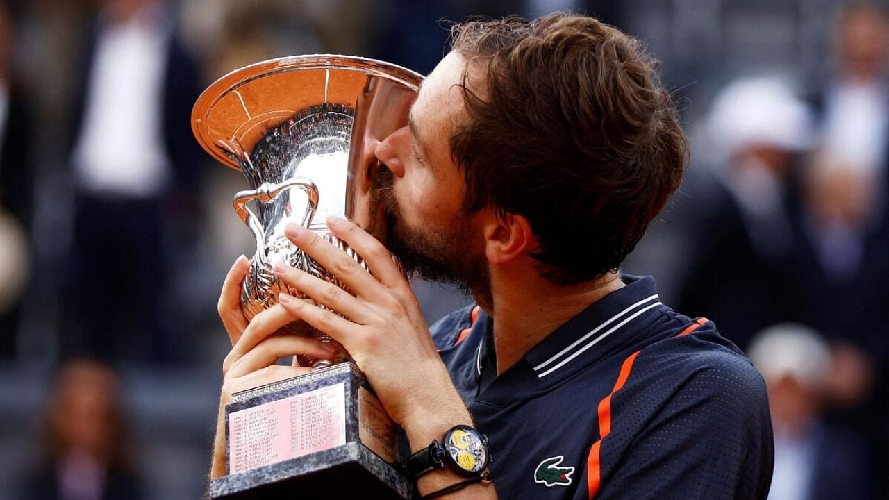 Russia's Daniil Medvedev kisses the trophy after winning the men's singles final against Denmark's Holger Rune. Credit: Reuters Photo