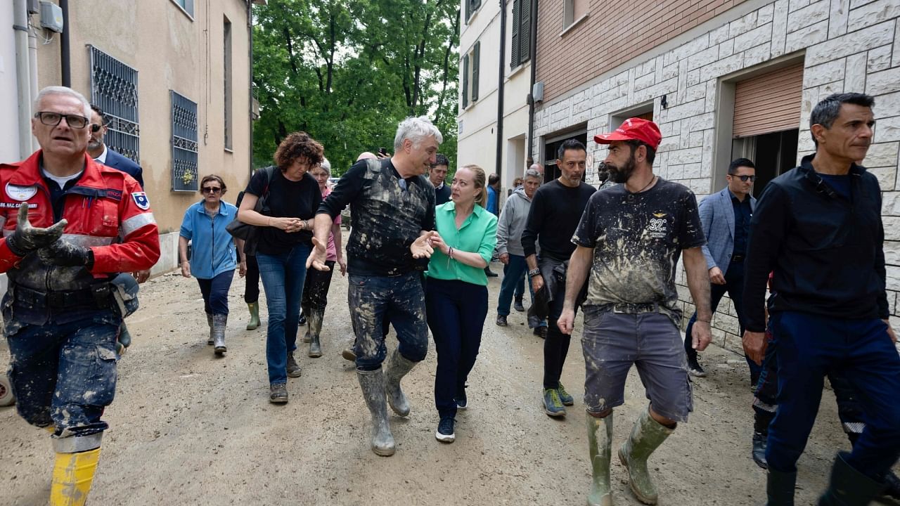 Italy's Prime Minister, Giorgia Meloni talking with a volunteer while visiting the town of Faenza after deadly floodwaters hit the Emilia-Romagna region. Credit: AFP Photo / Palazzo Chigi Press Office / Handout