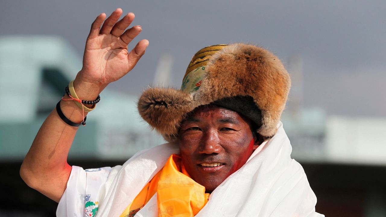 Nepalese veteran Sherpa guide Kami Rita waves as he arrives in Kathmandu, Nepal, May 20, 2018. Rita scaled Mount Everest Tuesday, May 23, 2023, for the 28th time beating his own record within a week as two guides compete with each other for the title of most climbs of the world's highest peak. Credit: AP/PTI File Photo