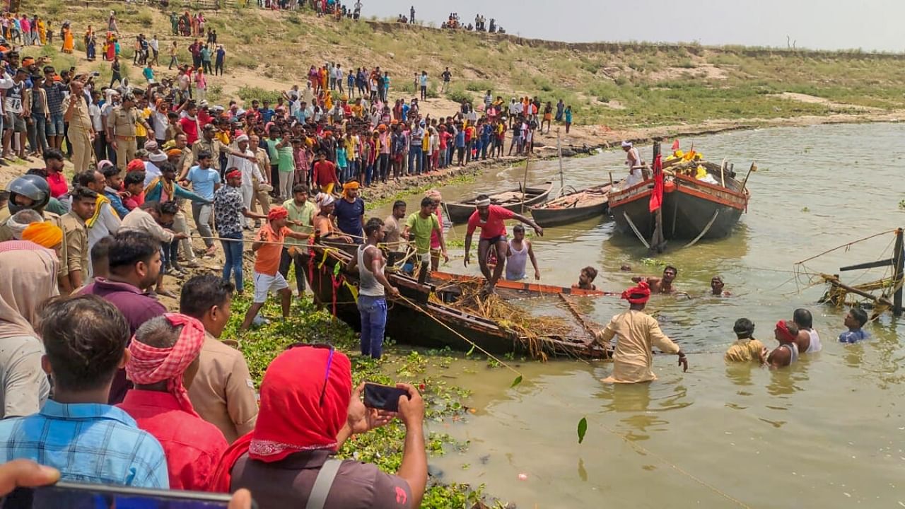 Rescue operation underway after a boat capsized at Maldepur Ganga Ghat, in Ballia, Monday, May 22, 2023. At least three people drowned in the incident, according to police. Credit: PTI Photo
