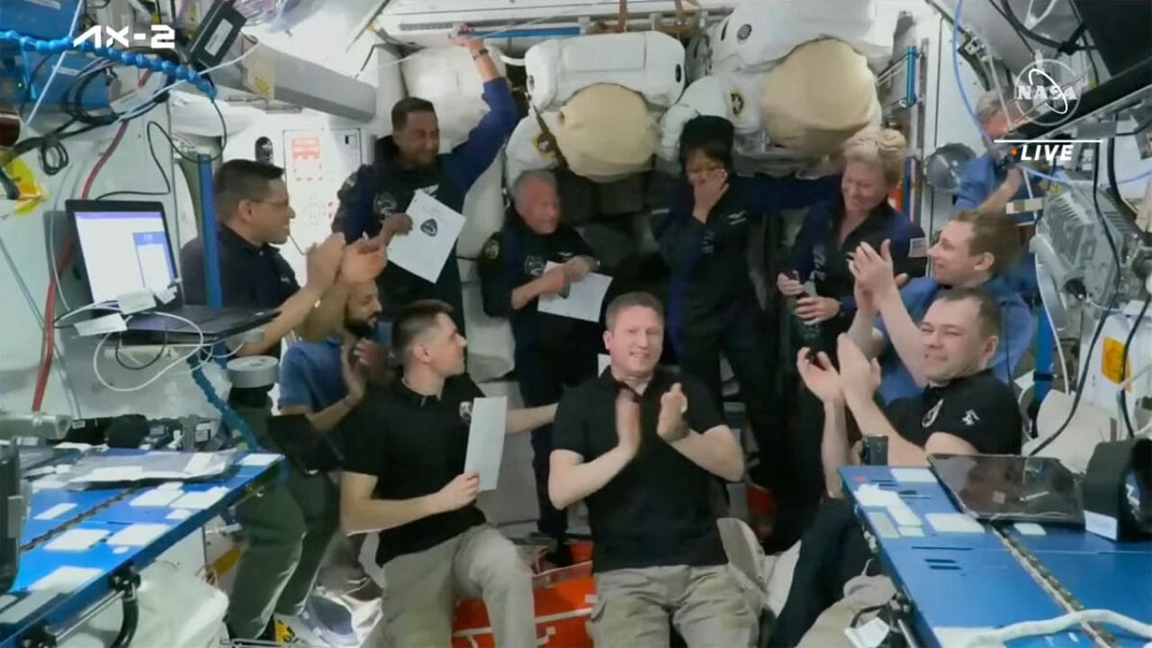 Mission specialist Rayyanah Barnawi, representing Saudi Arabia, reacts after she was given a pin as the 600th astronaut by Axiom Mission 2 (Ax-2) Commander Peggy Whitson after their crew's arrival on the International Space Station orbiting Earth. Credit: NASA TV/Handout via Reuters