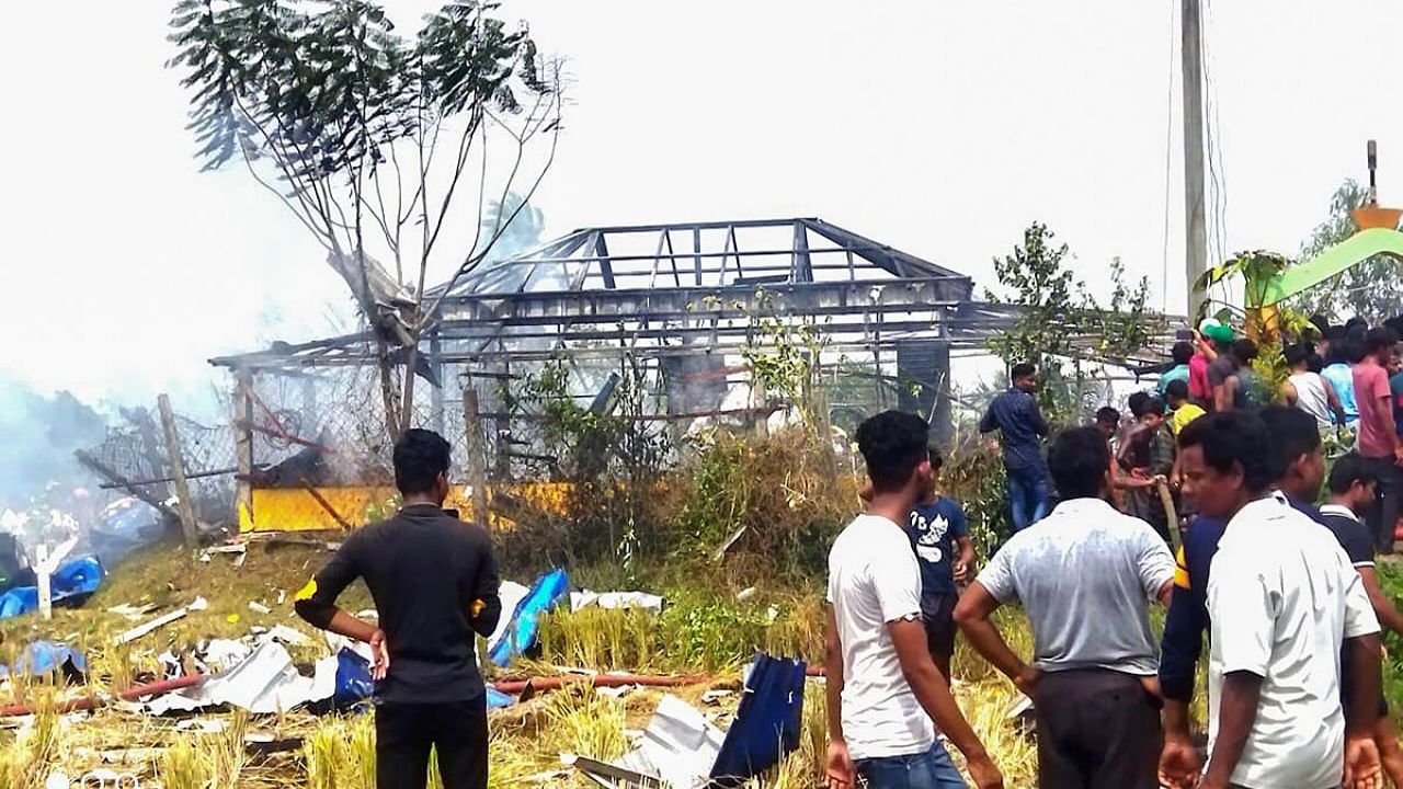 Locals outside an illegal firecracker unit after a massive explosion, in West Bengal's Purba Medinipur district, Tuesday, May 16, 2023. Credit: PTI Photo