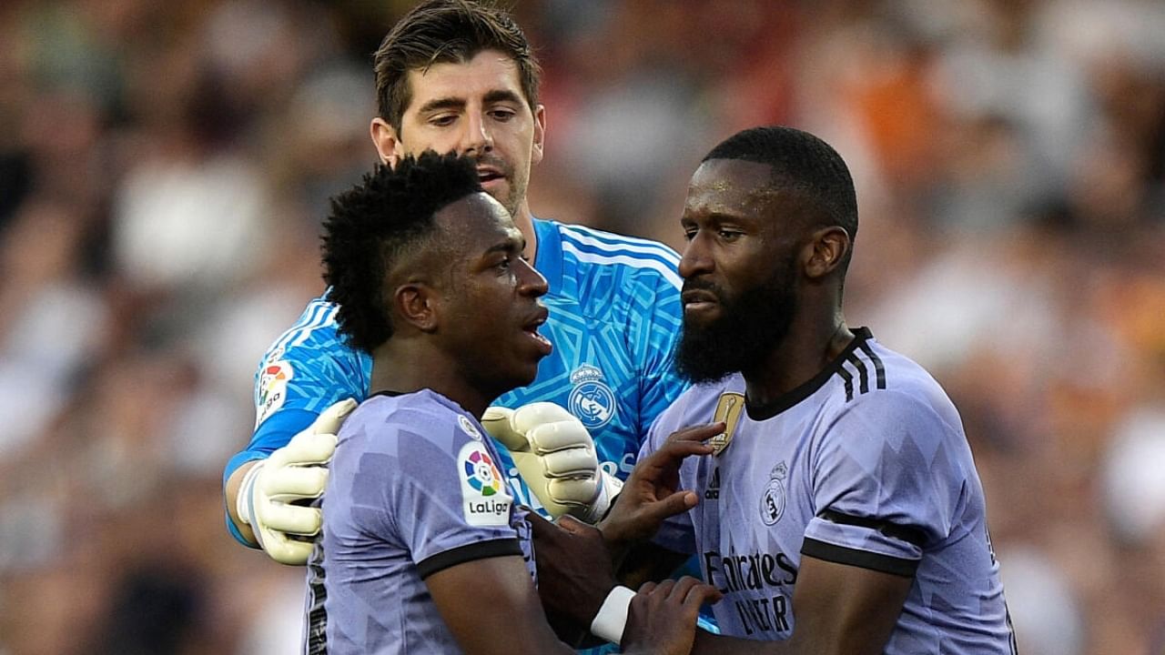 Real Madrid's Vinicius Junior is restrained by Antonio Rudiger and Thibaut Courtois after being sent off. Credit: Reuters Photo