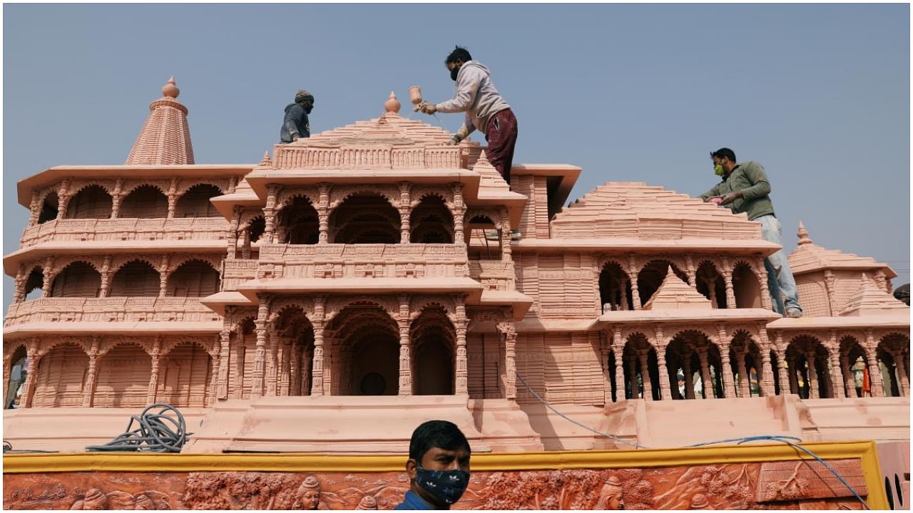 Workers give finishing touches to the model of the proposed Ram temple that Hindu groups want to build at a religious site in Ayodhya, on a tableau during a media preview of tableaux participating in the Republic Day parade in New Delhi, India January 22, 2021.Credit: Reuters Photo