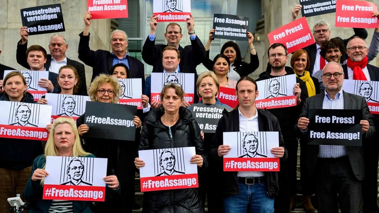 German MPs display "Free Assange" placards during a demonstration on the steps of the Reichstag building. Credit: AFP Photo