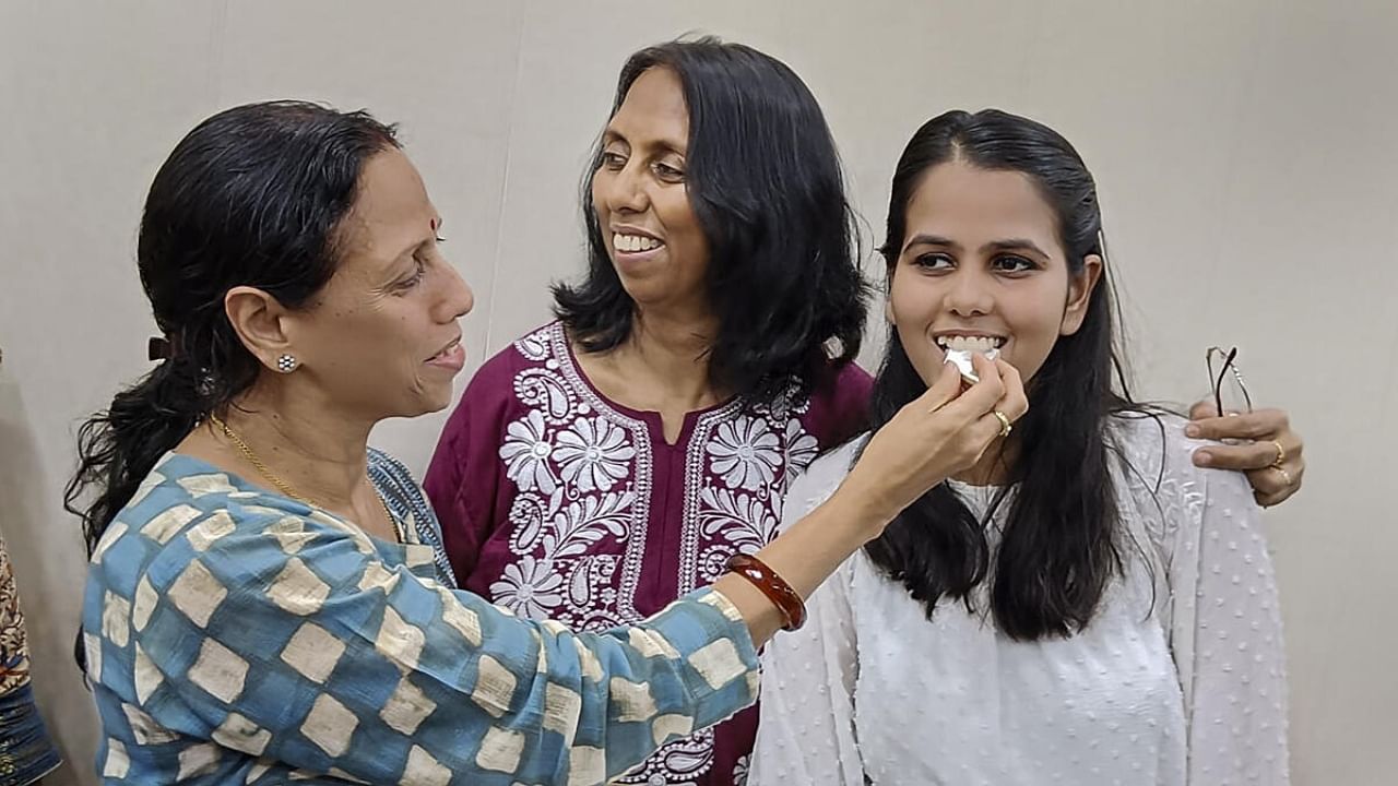 UPSC civil services examination 2022 topper Ishita Kishore celebrates with family members and relatives after the declaration of results, in Greater Noida. Credit: PTI Photo