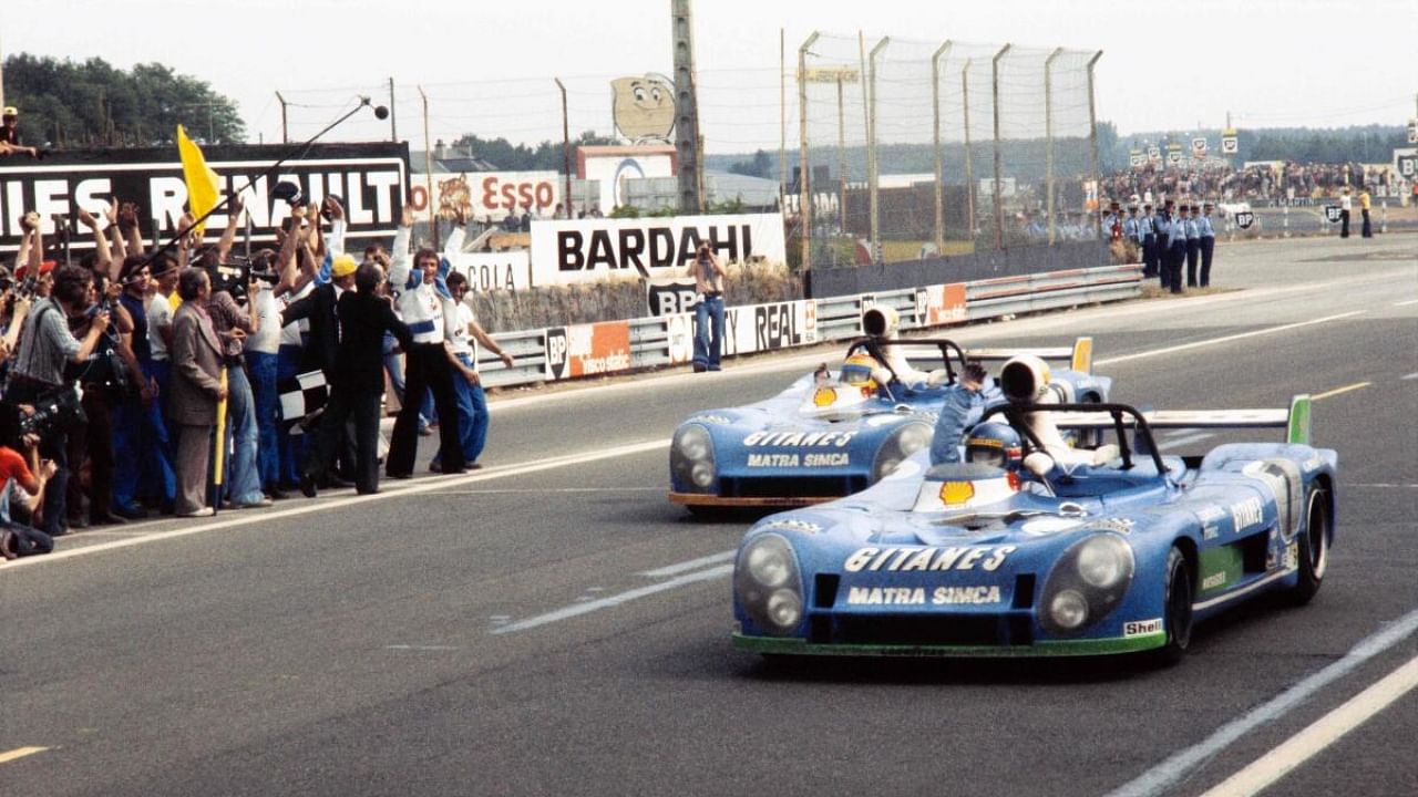 This photograph taken on June 16, 1974, shows the Equipe Gitanes team Matra Simca MS670 N°7 (R), driven by French Henri Pescarolo and Gérard Larrousse crossing the finish line, winning the 42nd edition of the 24 hours of Le Mans. Credit: AFP Photo
