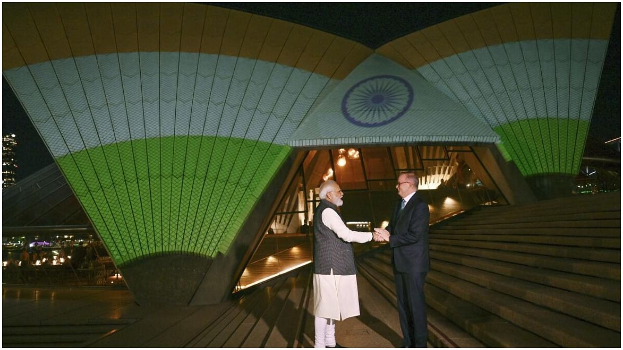 India's Prime Minister Narendra Modi and Australian Prime Minister Anthony Albanese are photographed in front of the sails of the Sydney Opera House illuminated in the colors of the Indian flag in Sydney, Wednesday, May 24, 2023. Credit: AP Photo
