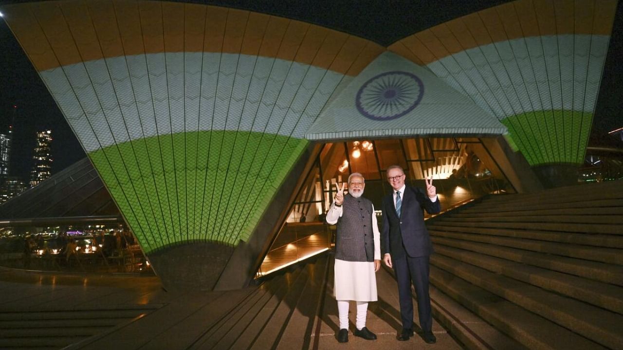 India's Prime Minister Narendra Modi and Australian Prime Minister Anthony Albanese are photographed in front of the sails of the Sydney Opera House illuminated in the colors of the Indian flag in Sydney, Wednesday, May 24, 2023. Credit: AP Photo