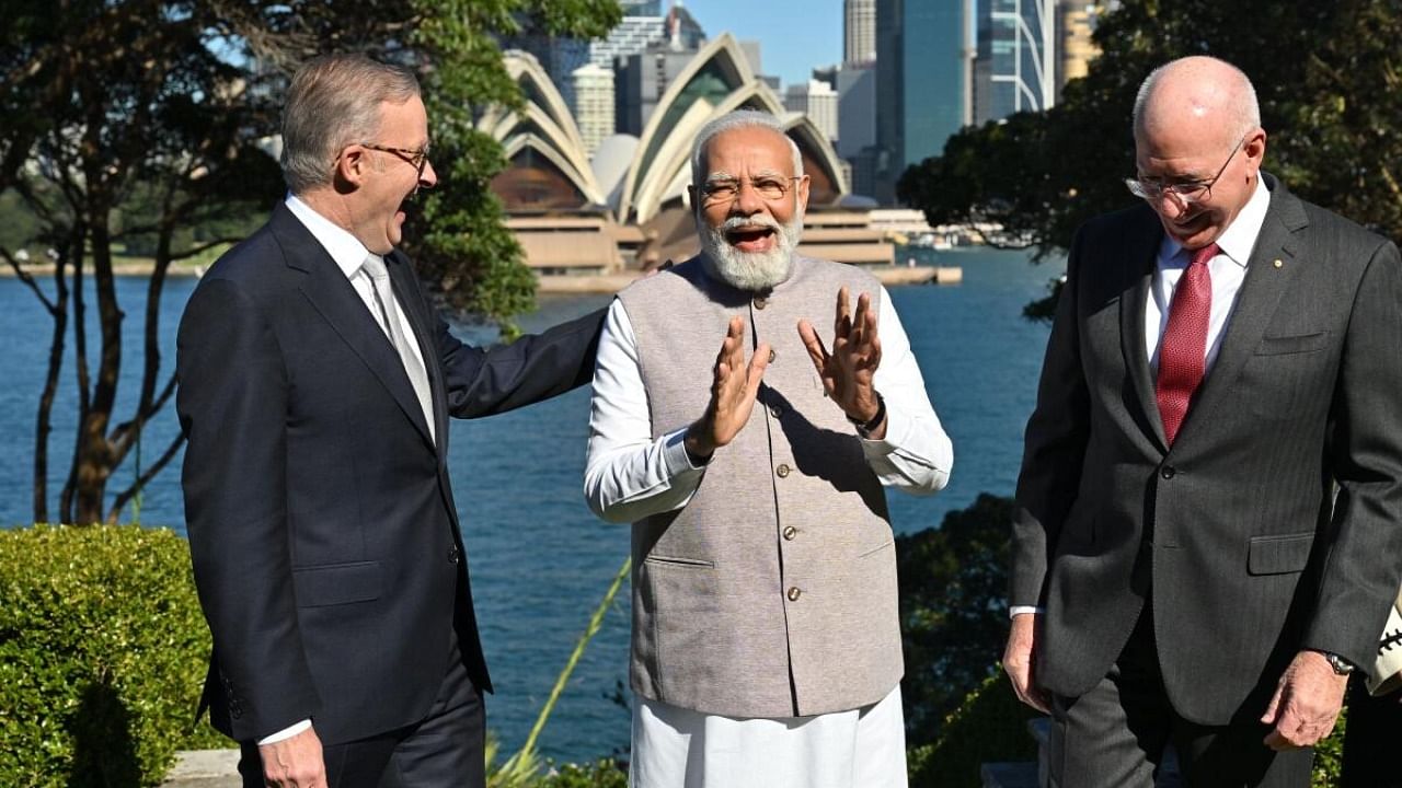India's Prime Minister Narendra Modi (C) speaks with Australia's Prime Minister Anthony Albanese (L) and Australia's Governor General David Hurley in front of the Sydney Opera House at Admiralty House in Sydney on May 24, 2023. Credit: AFP Photo