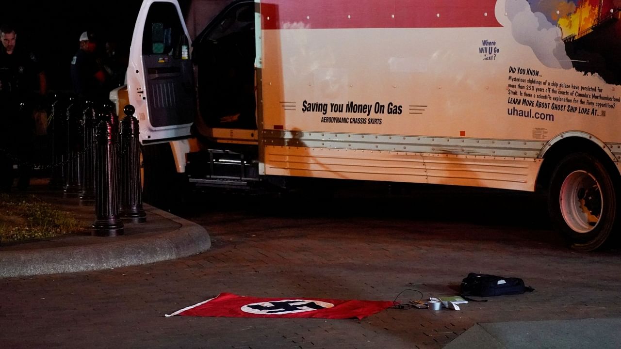 A Nazi flag and other objects recovered from a rented box truck are pictured on the ground as the US Secret Service and other law enforcement agencies investigate the truck that crashed into security barriers at Lafayette Park across from the White House in Washington, US, May 23, 2023. Credit: Reuters Photo