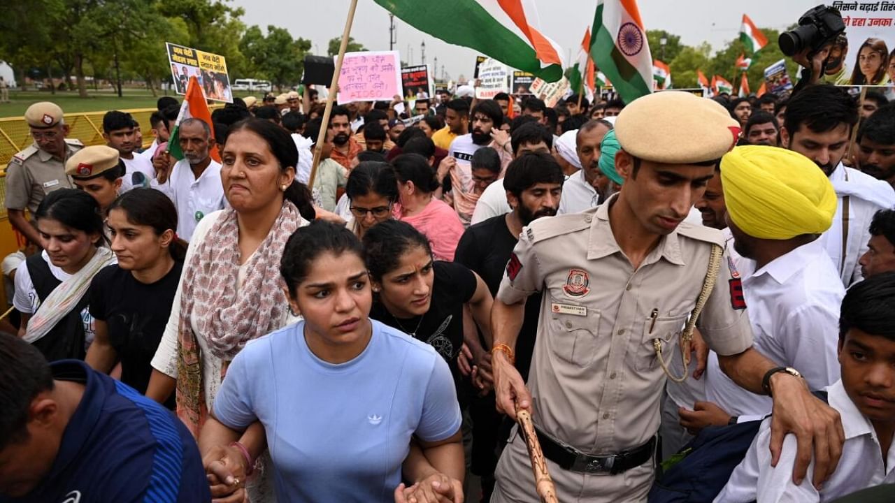 Carrying the national flag, the protesters marched to India Gate, near the parliament building, with a strong police presence accompanying them. Credit: AFP Photo