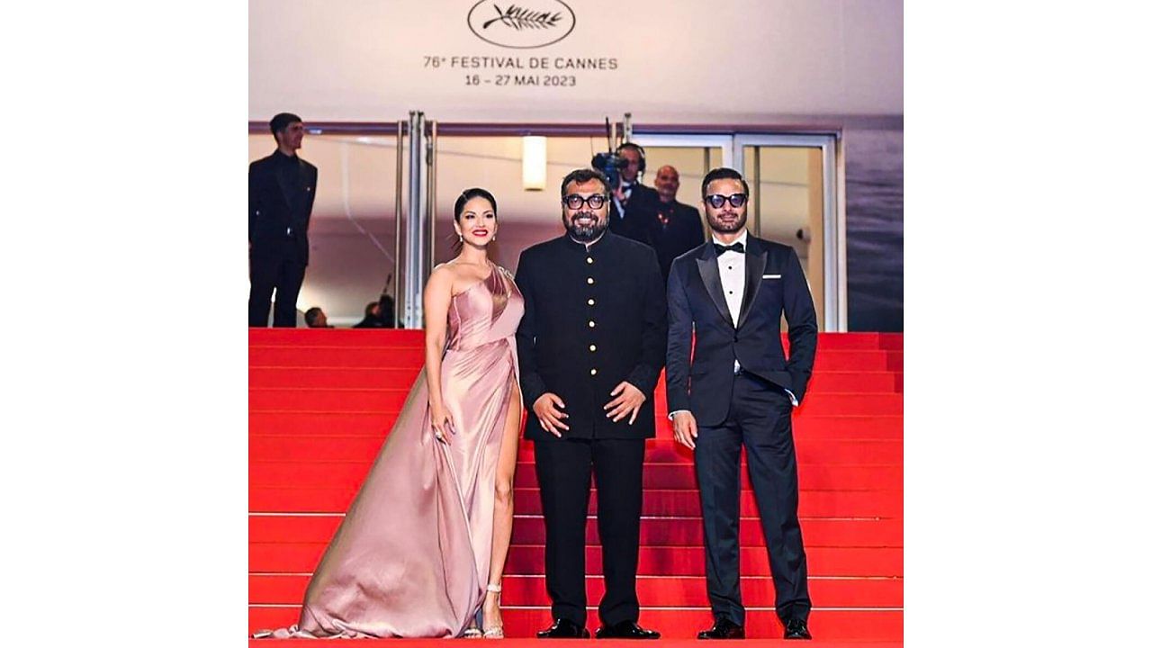 Actor Sunny Leone, director Anurag Kashyap (centre) and actor Rahul Bhat pose for photos on the red carpet ahead of the screening of their film 'Kennedy' at Cannes Film Festival. Credit: PTI Photo
