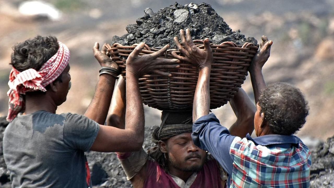 Workers prepare to load coal onto a truck at the Jharia coalfield in Jharkhand's Dhanbad. Credit: AFP Photo