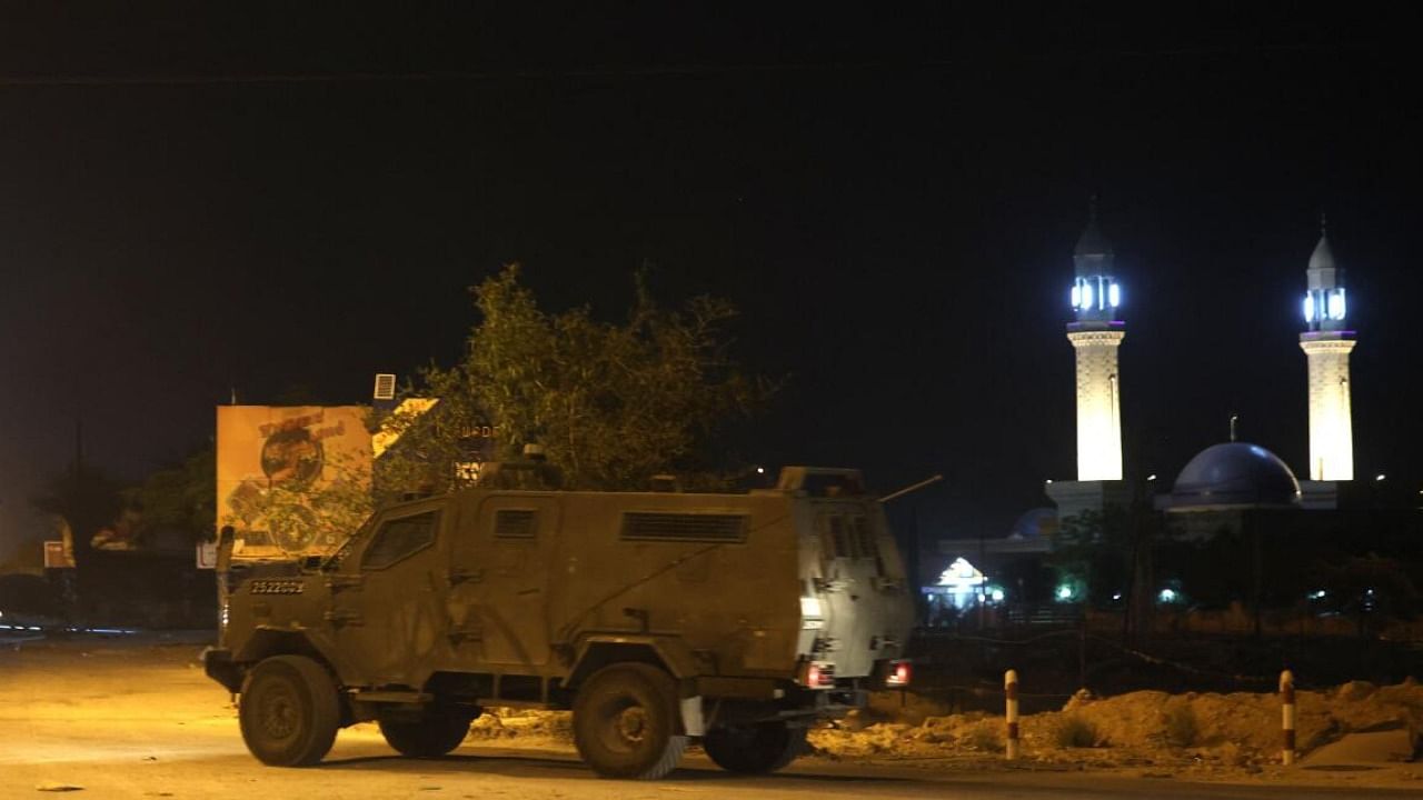 An Israeli forces armoured vehicle enters the Aqabet Jaber refugee camp near Jericho in the occupied West Bank. Credit: AFP Photo