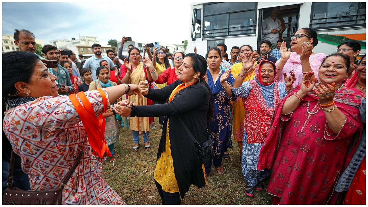 Kashmiri pandits dance as they prepare to leave for the annual 'Kheer Bhawani Mela', in Jammu, Friday, May 26, 2023. Credit: PTI Photo