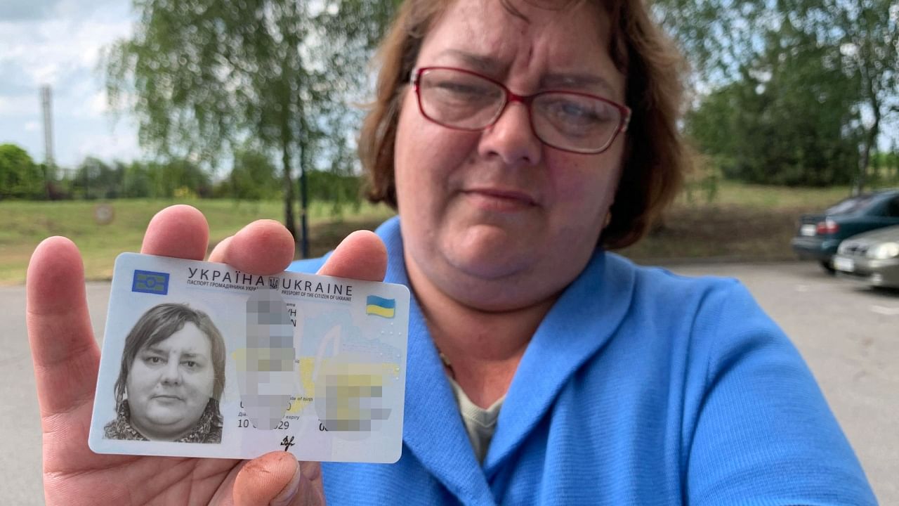 43-year-old Victoria holds her ID card, the Ukrainian internal pasport, in Zaporizhzhia on May 23, 2023. Credit: AFP Photo
