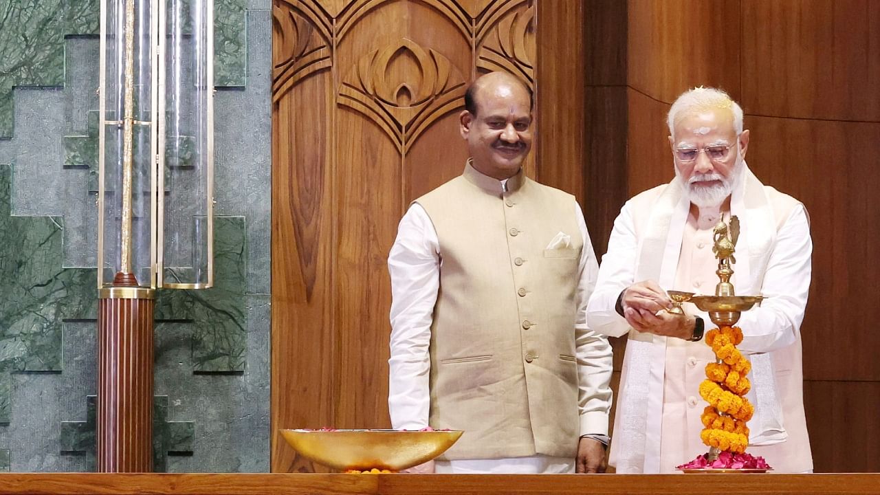 Prime Minister Narendra Modi lights a lamp after installing the 'Sengol' as Speaker of the Lok Sabha Om Birla looks on, during the inauguration of new Parliament building in New Delhi, India, May 28, 2023. Credit: Reuters via PIB