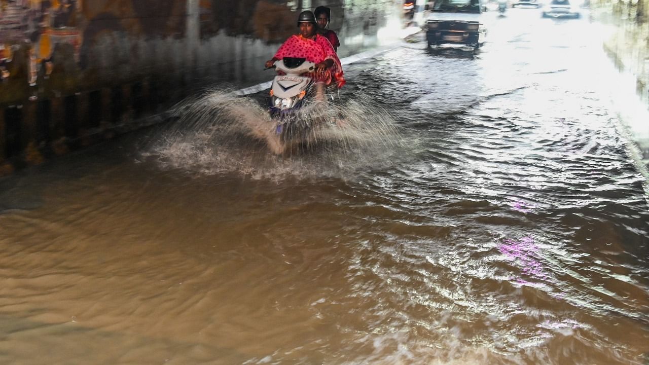 Rain water flooded on the road and motorist struggle to drive at Seshadripuram underpass, Hari Krishna Road in Bengaluru. Credit: DH Photo/S K Dinesh