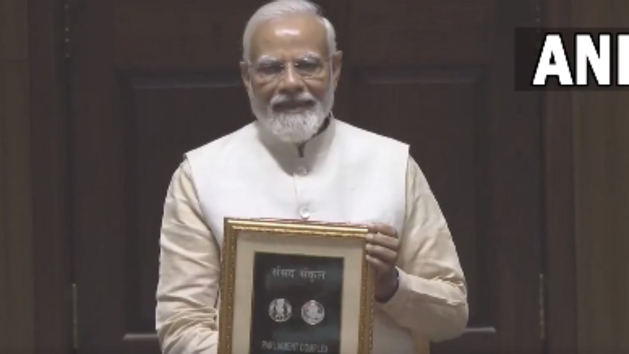 PM Narendra Modi releases a stamp and Rs 75 coin in the new Parliament. Credit: Twitter / @ANI