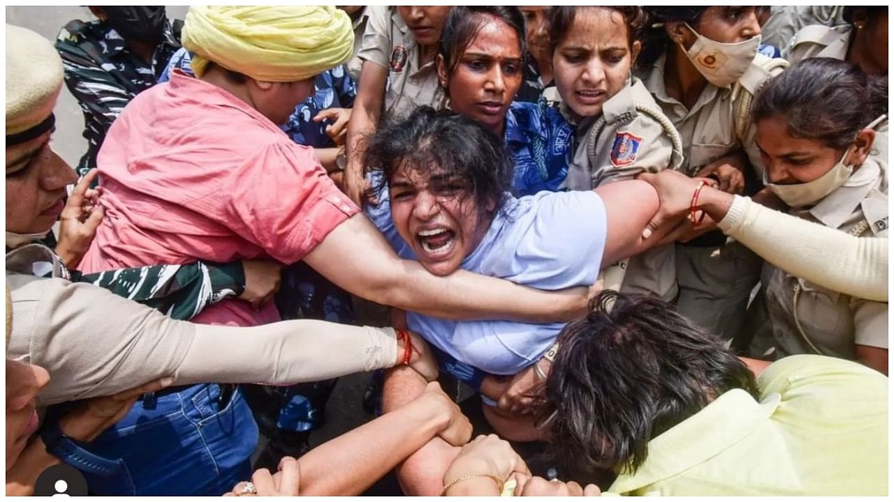 Wrestler Sakshi Malik being detained by police during wrestlers' protest march towards new Parliament building, in New Delhi. Credit: IANS Photo