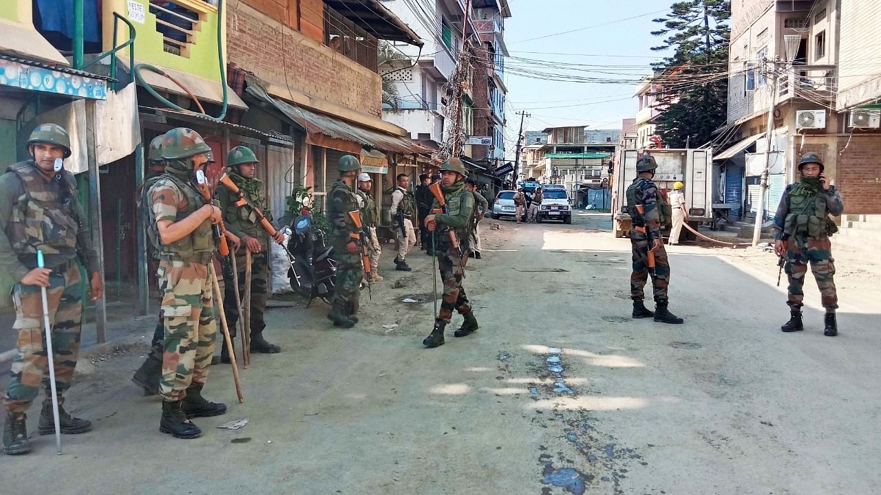 Army personnel stand guard in violence-hit area of Imphal town. Credit: IANS Photo