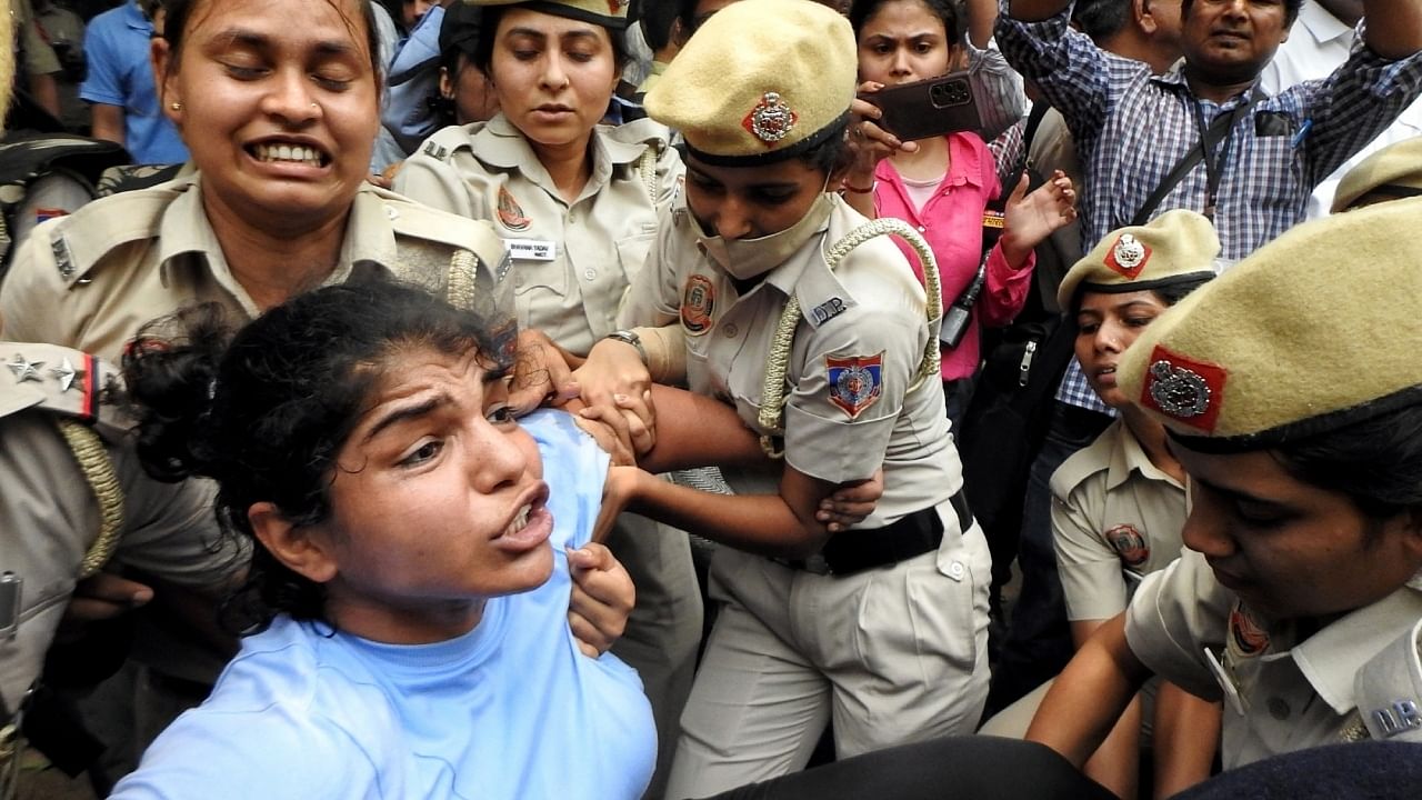 Wrestler Sakshi Malik being detained by the Delhi police during the wrestlers' protest march towards the new Parliament building, in New Delhi, Sunday, May 28, 2023. Credit: IANS Photo