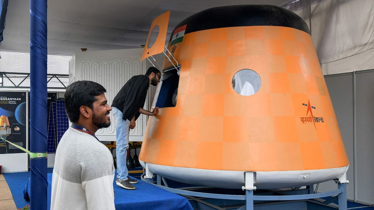 Visitors look at an actual scale model of “Gaganyaan Orbital Module”, India’s first manned space flight at the Human Space Flight Expo organised by the Indian Space Research Organisation (ISRO) at the Jawaharlal Nehru Planetarium in Bangalore on July 21, 2022. Credit: AFP Photo