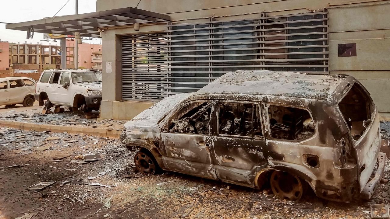 Destroyed vehicles are pictured outside the burnt-down headquarters of Sudan's Central Bureau of Statistics, on al-Sittin (sixty) road in the south of Khartoum on May 29, 2023. Credit: AFP Photo