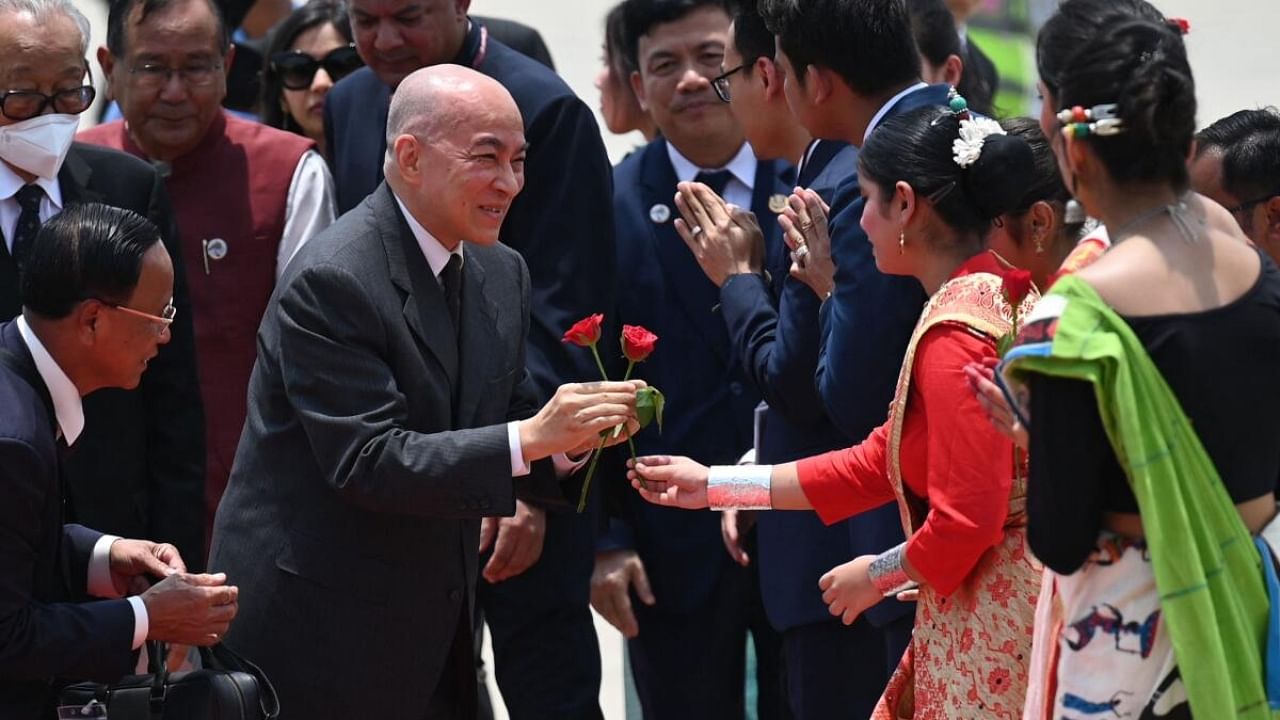 Cambodia's King Norodom Sihamoni (C) is welcomed upon his arrival at the airport in New Delhi. Credit: AFP Photo