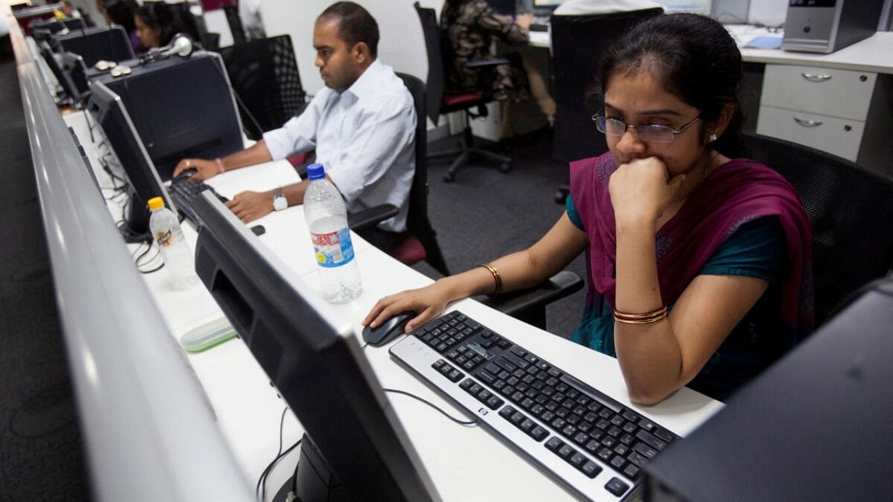 Workers are seen at their workstations on the floor of an outsourcing centre in Bangalore. Credit: DH File Photo