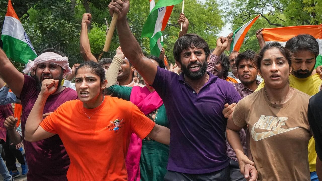Wrestlers Vinesh Phogat, Sangeeta Phogat and Bajrang Punia with supporters during their protest march towards new Parliament building, in New Delhi. Credit: PTI Photo
