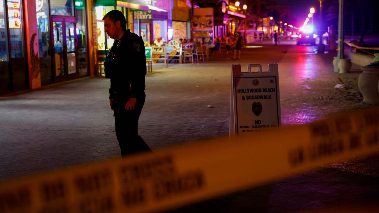 A law enforcement officer is seen on a crime scene as they respond to a shooting at Hollywood Beach. Credit: AFP Photo