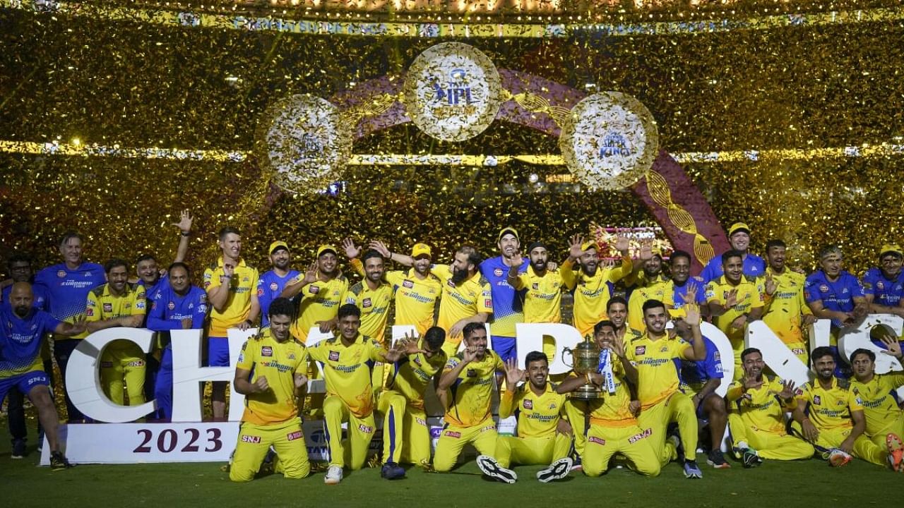 Chennai Super Kings players celebrate with the trophy after winning the Indian Premier League (IPL) 2023. Credit: PTI Photo