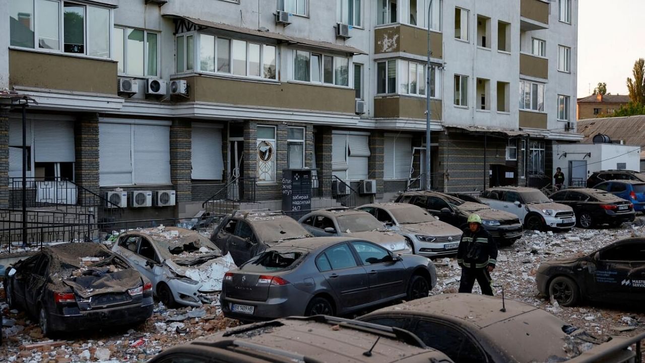 A firefighter walks near cars damaged during a massive Russian drone strike, amid Russia’s attack on Ukraine, in Kyiv, Ukraine May 30, 2023. Credit: Reuters Photo