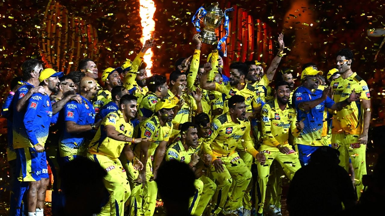 Chennai Super Kings' players celebrate with the trophy after their victory against Gujarat Titans in the Indian Premier League final at the Narendra Modi Stadium in Ahmedabad on Tuesday. Credit: AFP Photo