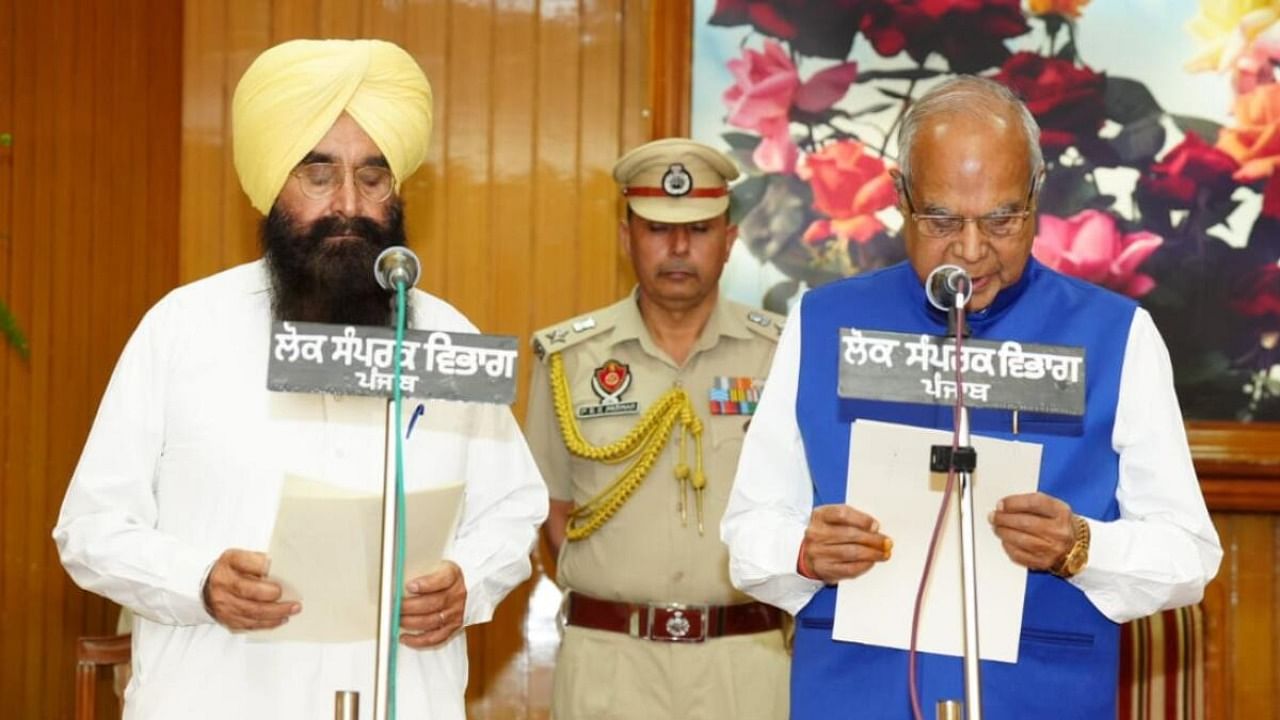 Punjab Governor Banwarilal Purohit administers oath to Gurmeet Singh Khudian as Punjab Minister, in Chandigarh, May 31, 2023. Credit: IANS Photo