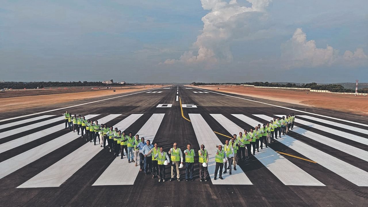 Mangaluru International Airport teams sign off with a V to mark end of runway recarpeting work. Credit: Special Arrangement