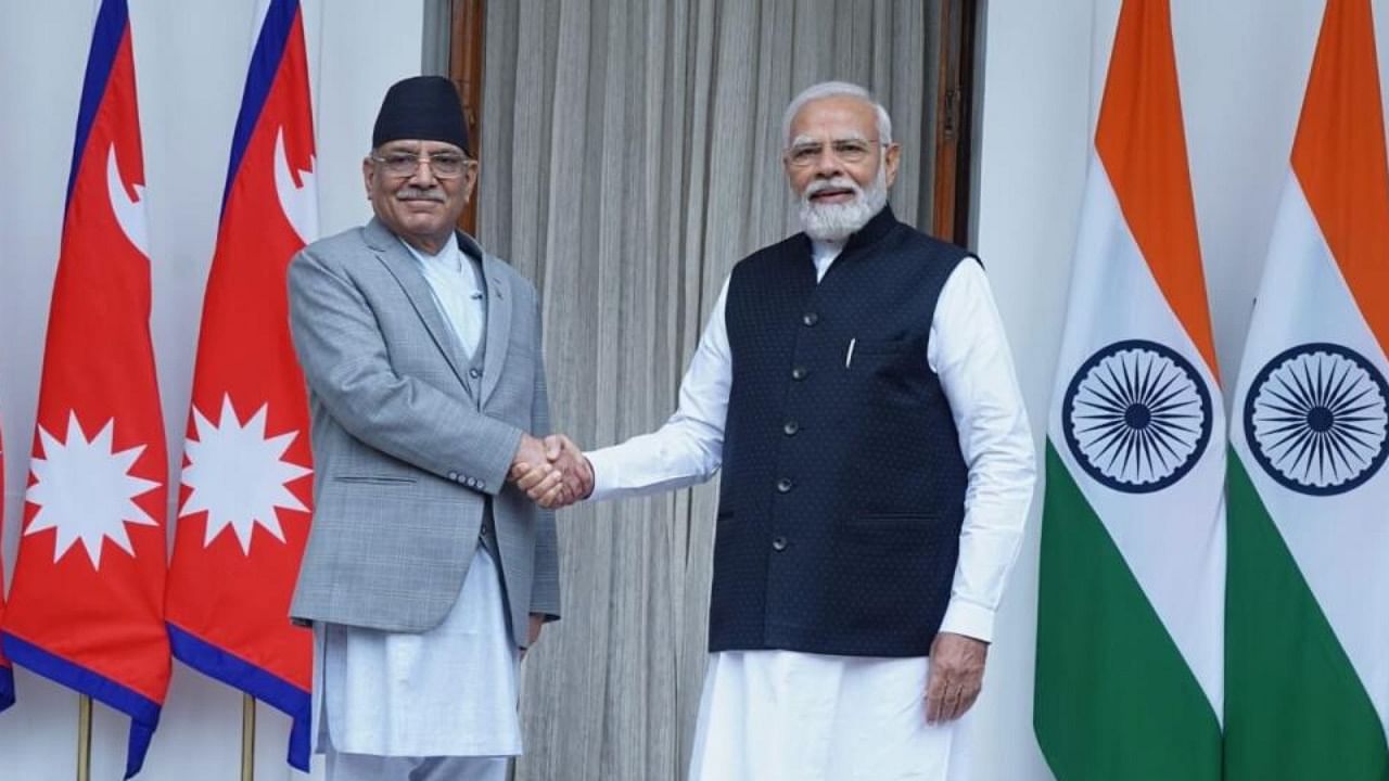 PM Narendra Modi greets Nepal PM Prachanda. Credit: IANS Photo