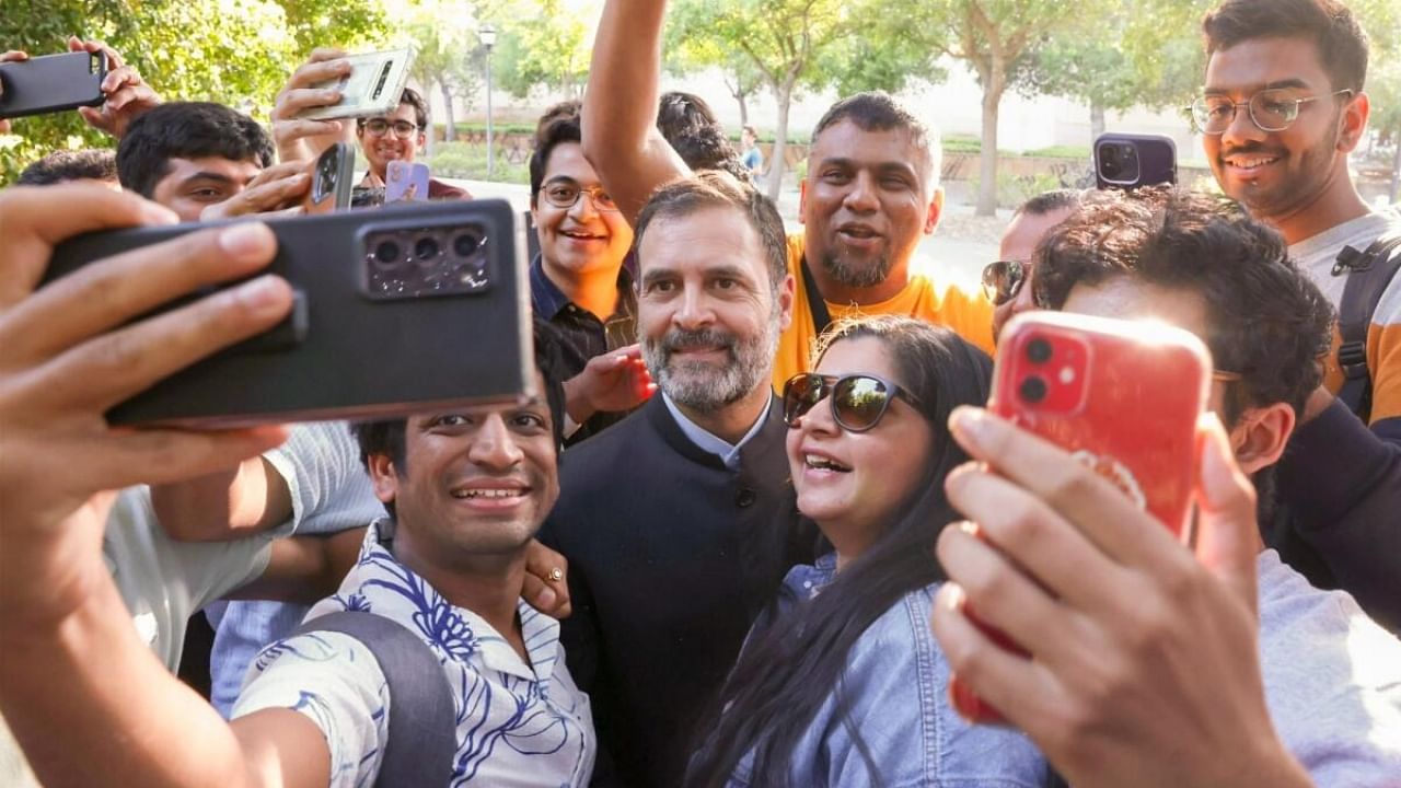 Rahul Gandhi takes selfies with students at Stanford. Credit: IANS Photo