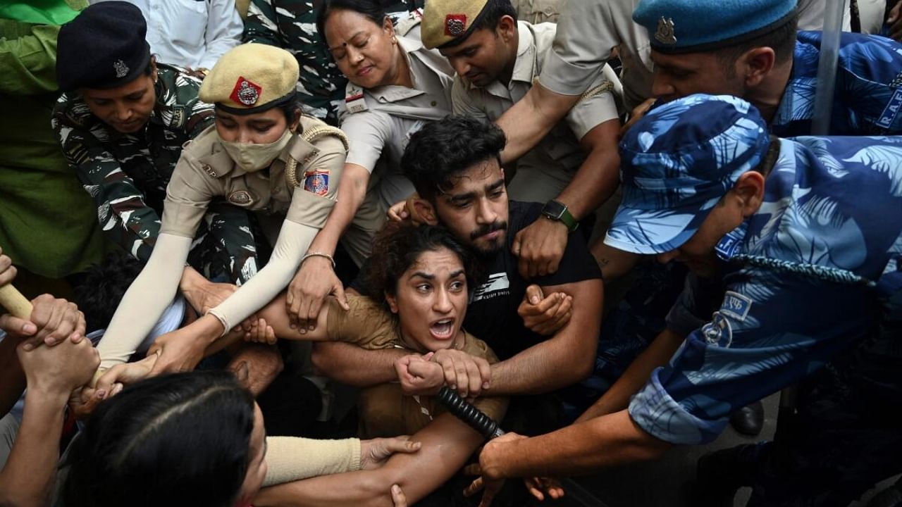 Indian wrestlers Vinesh Phogat (C) with others are detained by the police while attempting to march to India's new parliament during a protest against Brij Bhushan Singh, in New Delhi on May 28, 2023. Credit: AFP Photo