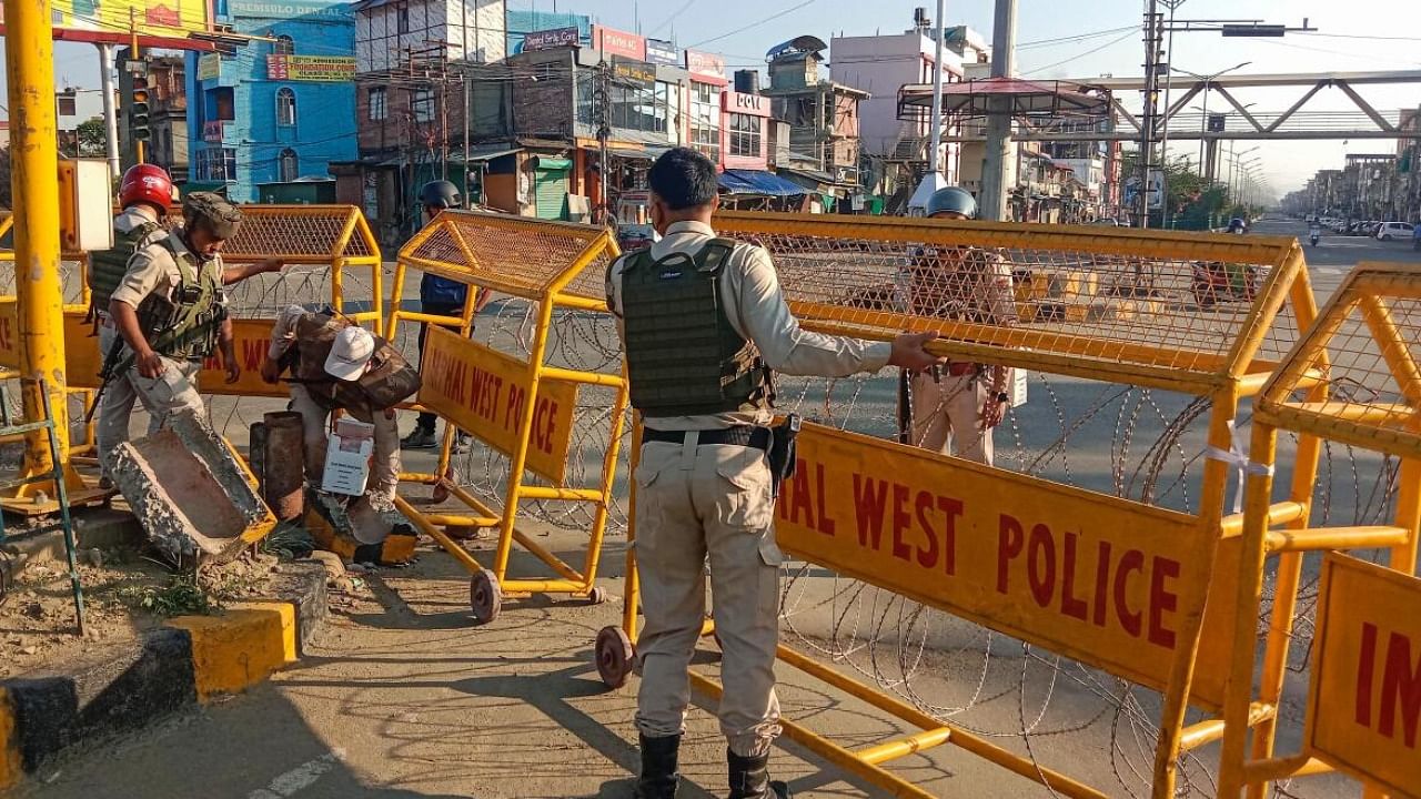 Police personnel stand guard in a violence-hit area of Imphal town, Manipur. Credit: PTI Photo