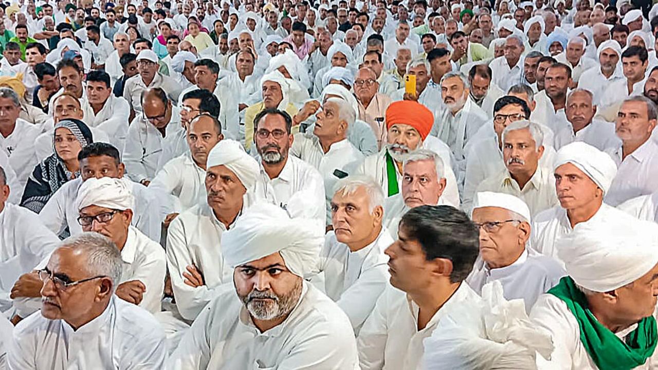 Bharatiya Kisan Union leader Rakesh Tikait with other union leaders during a 'Khap Mahapanchayat' to deliberate on the next steps to be taken in the agitation pertaining to the ongoing wrestlers' issue. Credit: PTI Photo