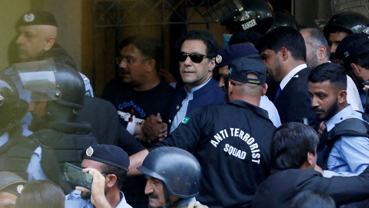 Security officers escort Pakistani former Prime Minister Imran Khan as he appeared in Islamabad High Court, Islamabad, Pakistan, May 12, 2023. Credit: Reuters File Photo