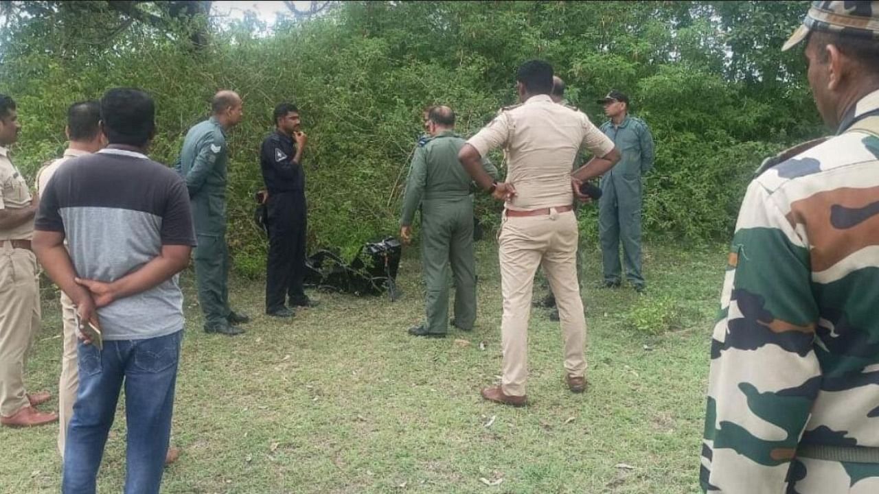 Indian Air Force officials inspect the site of crash, in Sappayyanapura village in Chamarajanagar on Friday. Credit: DH Photo