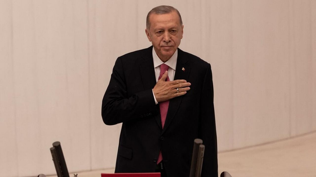 Turkish President Tayyip Erdogan greets members of the parliament and guests as he arrives to take his oath after his election win in Ankara, Turkey, June 3, 2023. Credit: Reuters Photo