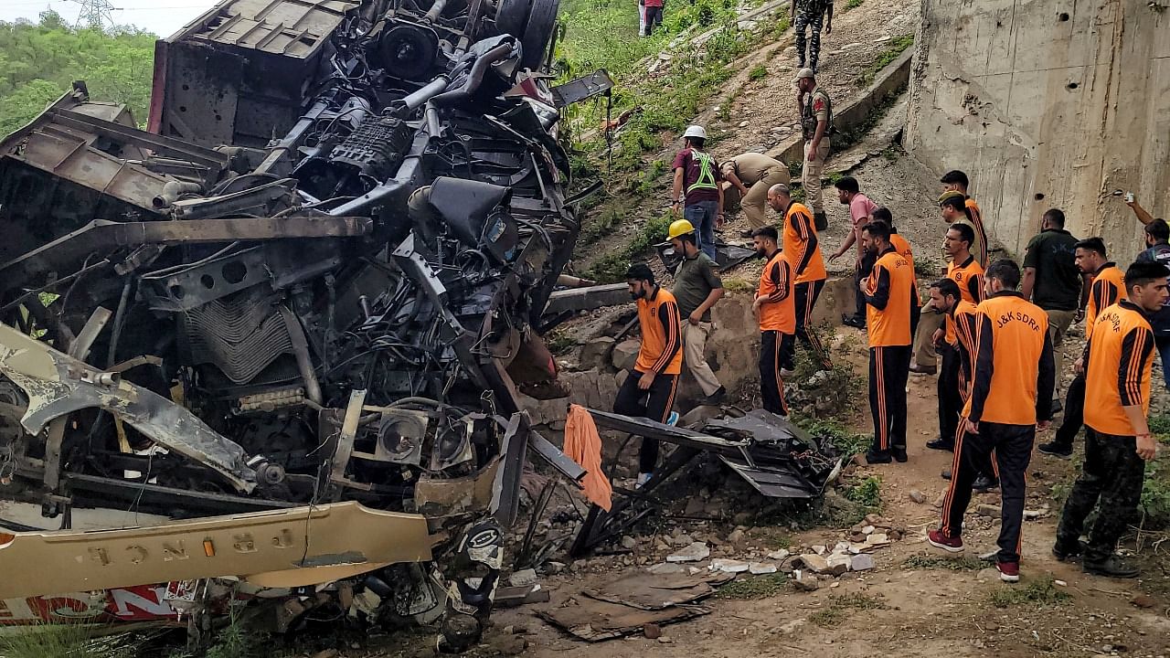 Rescue teams checks the wreckage of a bus after an accident in which several passengers were feared dead, in Jhajjar Kotli, near Jammu. Credit: PTI Photo