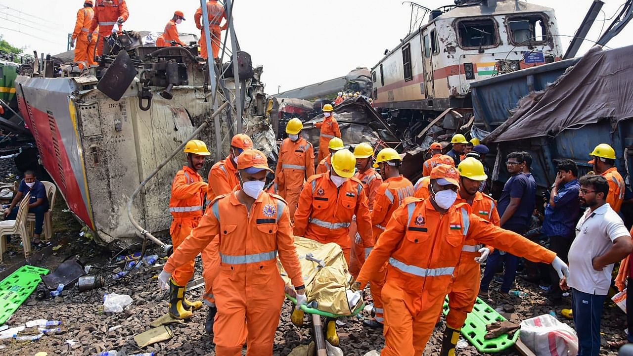 NDRF personnel carry out rescue work after an accident involving Coromandel Express, Bengaluru-Howrah Express and a goods train. Credit: PTI Photo